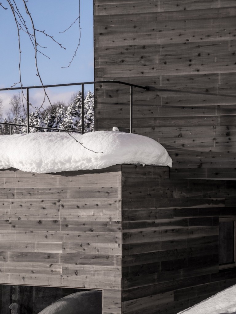 Close-up of Silvered Timber Cladding of L House with layer of Snow