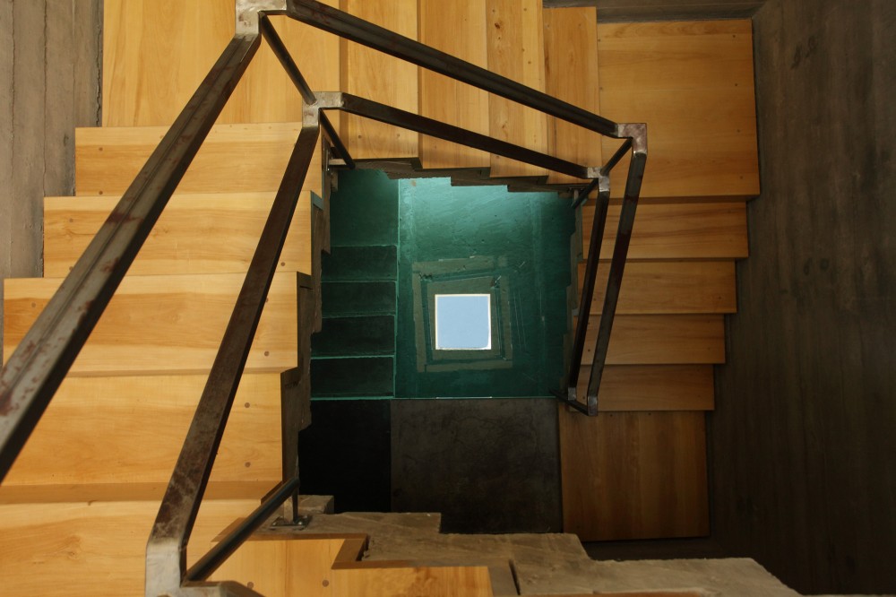 View Down Staircase to Concrete Pool with Reflection