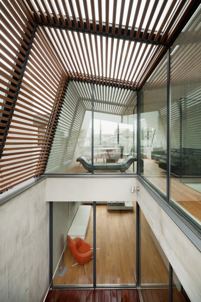Open Space within Skycourt House Covered by Angular Wooden Slatted Roof Cap