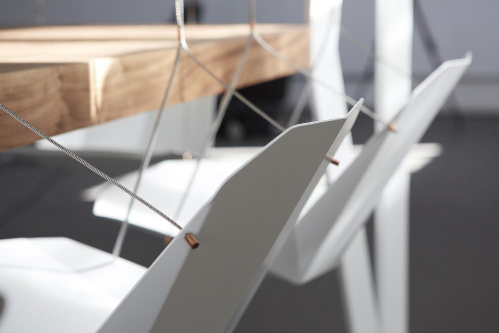 Close-up of Suspended Low-Poly Chair Frames in Swing Table