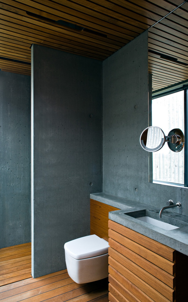Árborg House Bathroom with Blue-Grey Concrete and Warm Teak Wood
