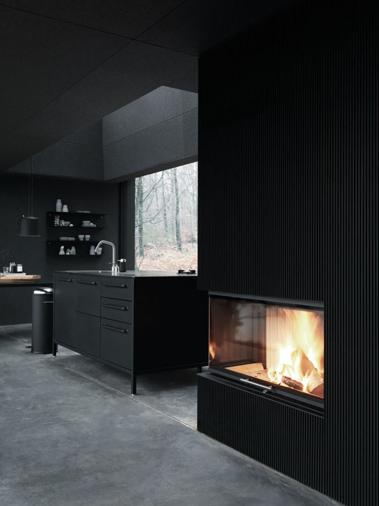 All Black Interior Kitchen adn Fireplace in Vipp Shelter
