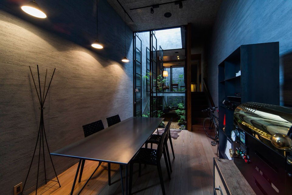 Dark Grey Interior Design with Contrasting Lights and Plants