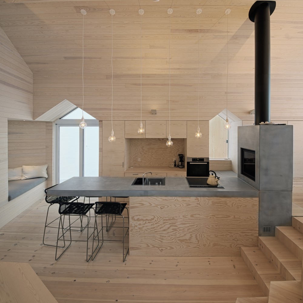 Minimalist Polished Concrete and Wood Kitchen and Breakfast Bar in Split View Mountain Lodge