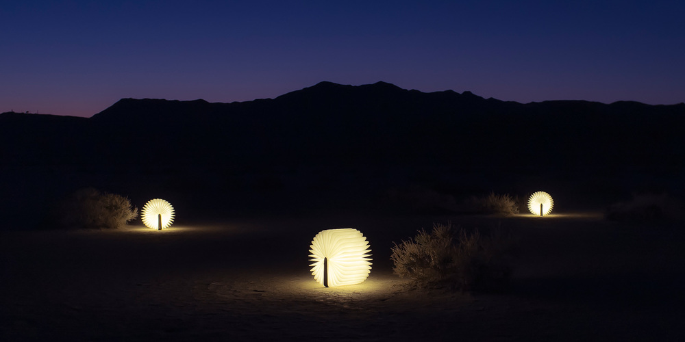 Scattered Lumio Books Glowing in Desert