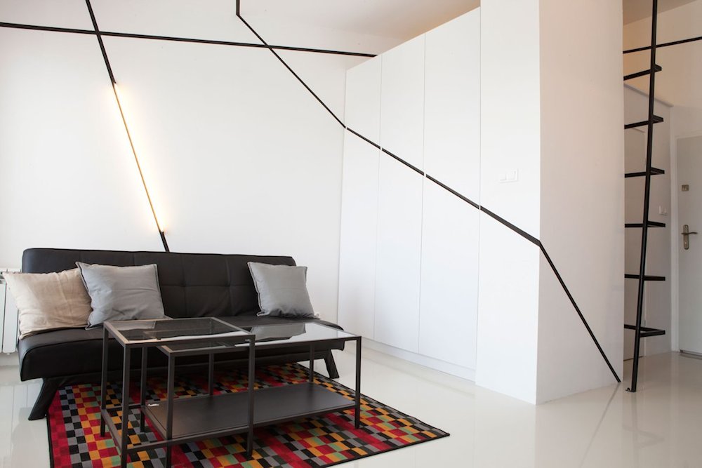 Sofa in Peter's Flat with Minimalistic Intersecting Planes on Walls