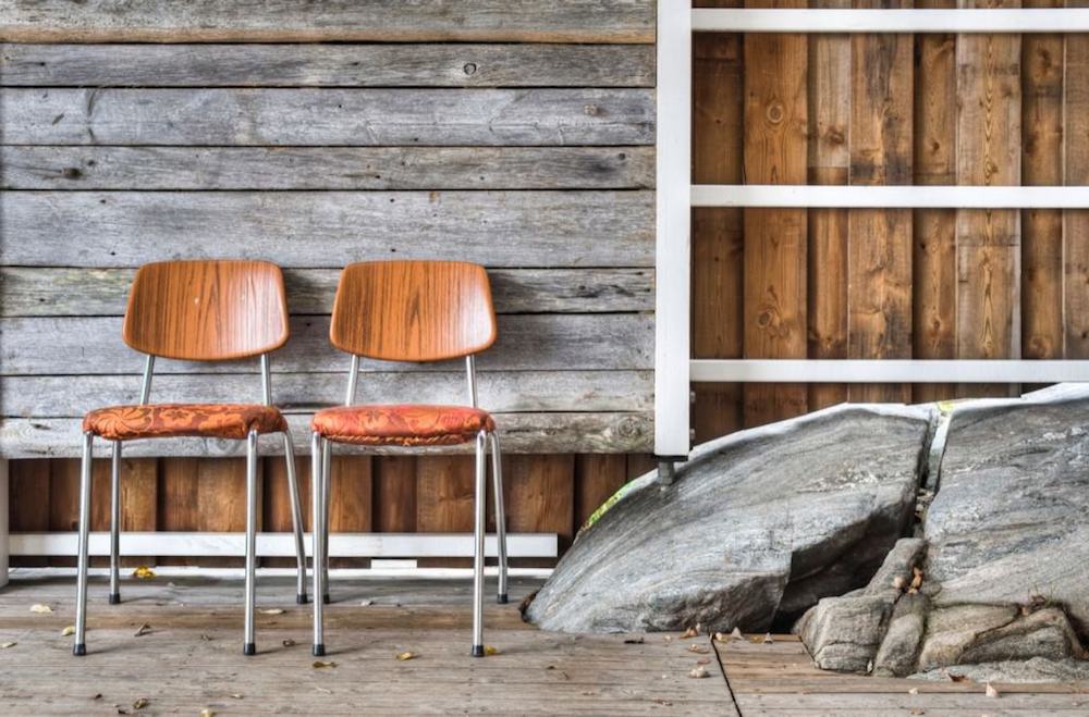 Two Chairs and Protruding Rock into Boathouse