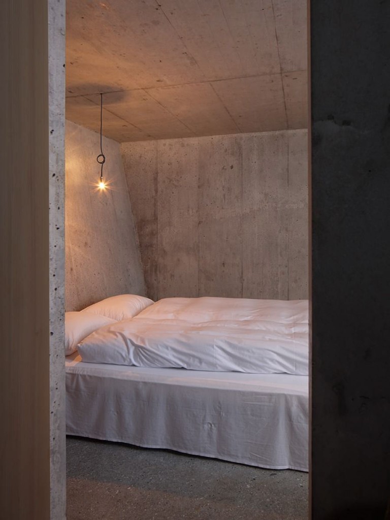 Concrete Bedroom with Industrial Light Fitting