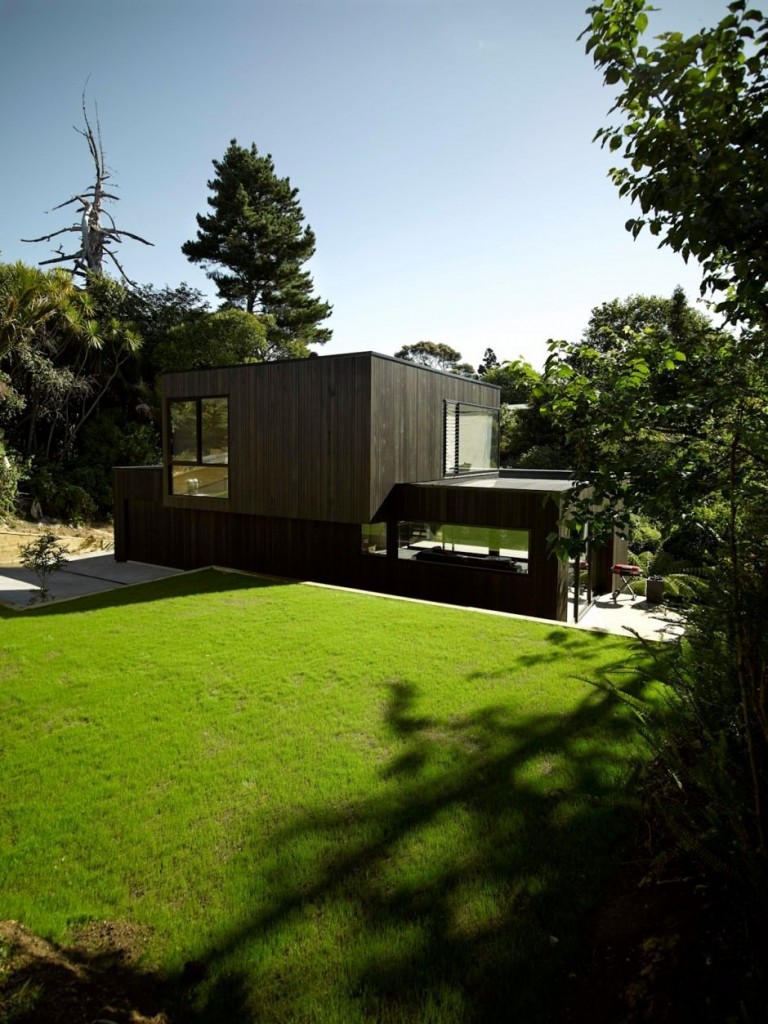 Green Lawn Contrasted against Stark Black Timber Cladding at Waiatarua House