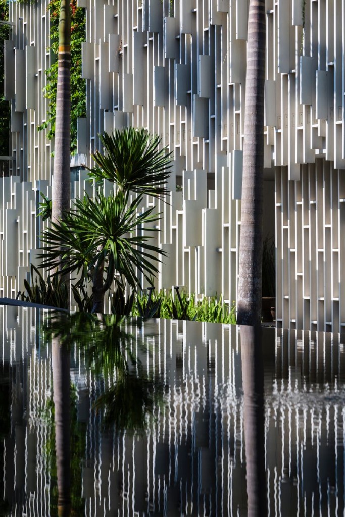 Reflections of White Lattice Exterior of Naman Spa in Water